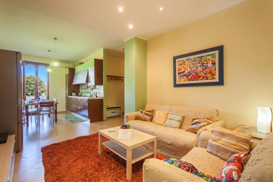 Family Apartment, 2 Bedrooms, Balcony (Happy Apartment Nettuno Close To Sea) | Living room | Flat-screen TV