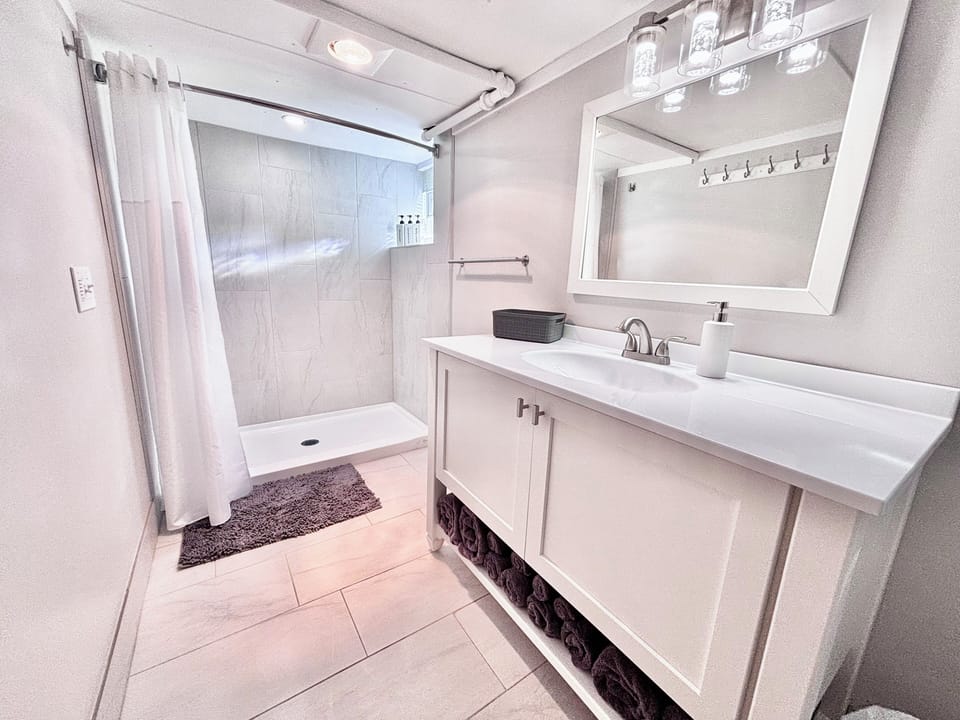 The basement bathroom with Amish-built vanity, heat lamp, and plush towels