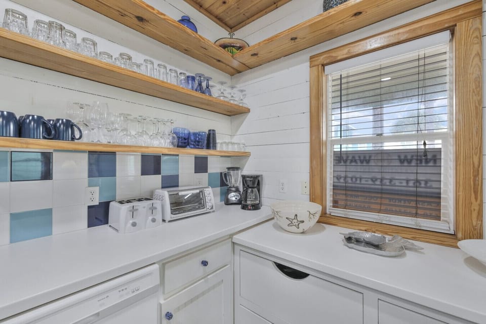 Well-appointed kitchen with modern appliances and coastal charm