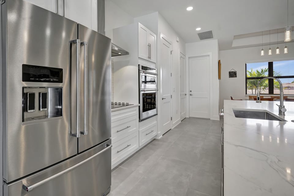 The kitchen is spacious; a view towards the garage and front of the home