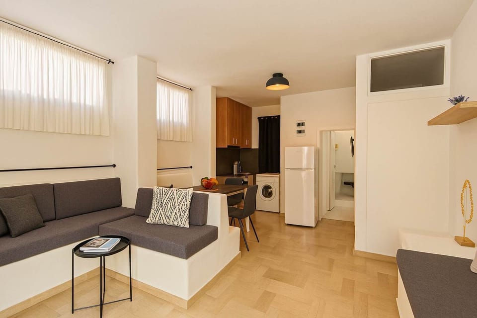 Bright open-plan lounge with sectional sofa, perfect for unwinding after the beach

