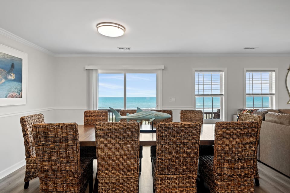 Your dining table frames uninterrupted ocean views through floor-to-ceiling windows—perfect for savoring morning coffee or sunset dinners by the sea.