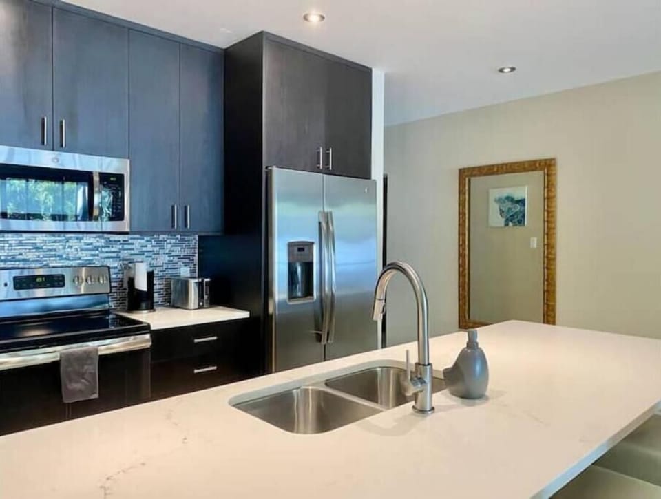 Fully stocked kitchen with modern appliances & coffee makers