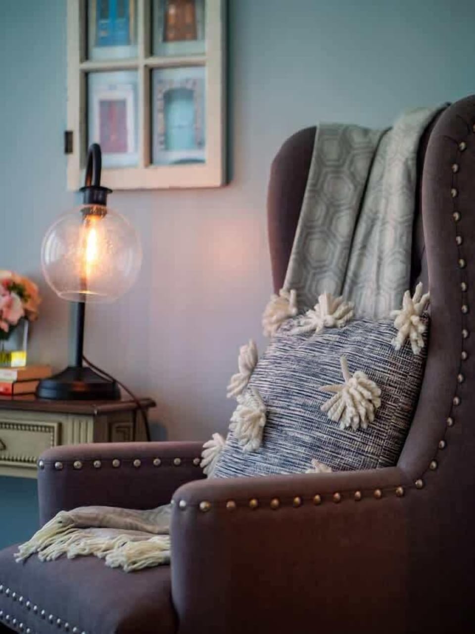 Enjoy abundant natural light in this versatile sunroom/office, featuring a sleek black desk, plush armchairs, and ornate patterned tile floors. Perfect for work or relaxation with airy sheer curtains and a touch of greenery! ☀️
