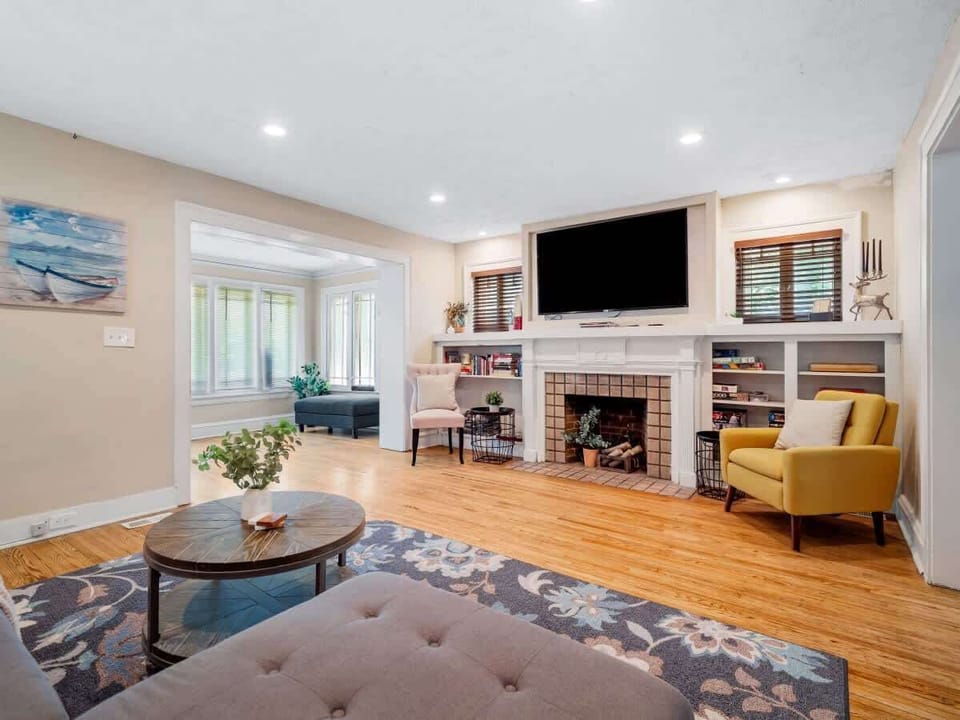 Open living room w/ fireplace, TV & seating arranged for easy gatherings
