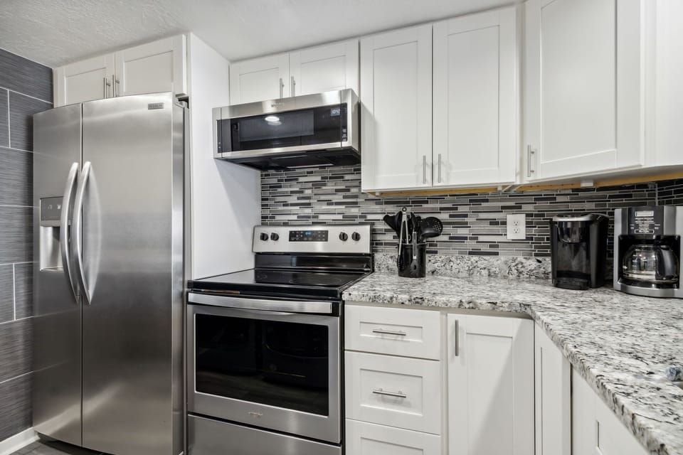 Sparkling White, Completely Remodeled Kitchen with Granite Countertops and Stainless Steel Appliances