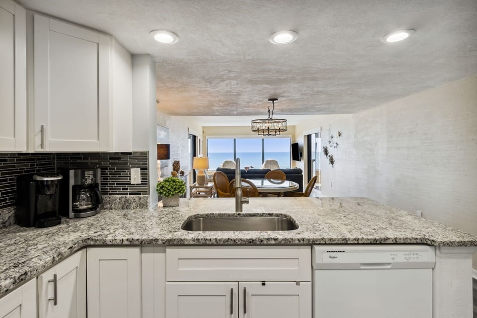 Sparkling White, Completely Remodeled Kitchen with Granite Countertops and Stainless Steel Appliances