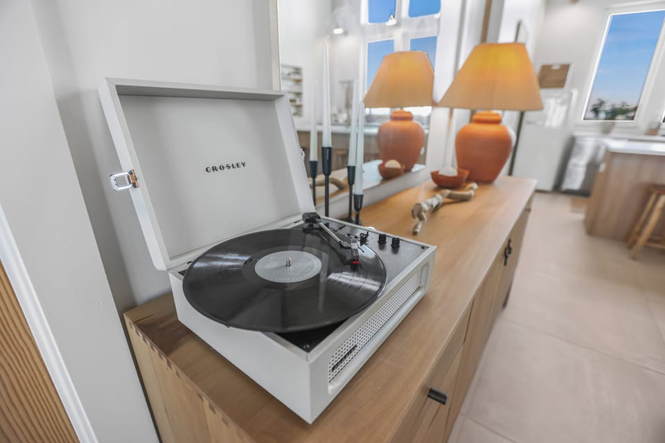 Spin some tunes and set the mood with our curated collection of vinyl. 