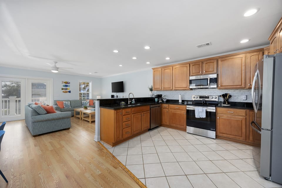 You'll love our fully stocked kitchen that is completely open to the living area. A guest mentioned "kitchen has everything you need to make your meals and more."