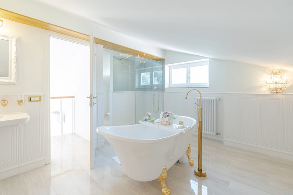 Separate tub and shower, designer toiletries, hair dryer, bathrobes