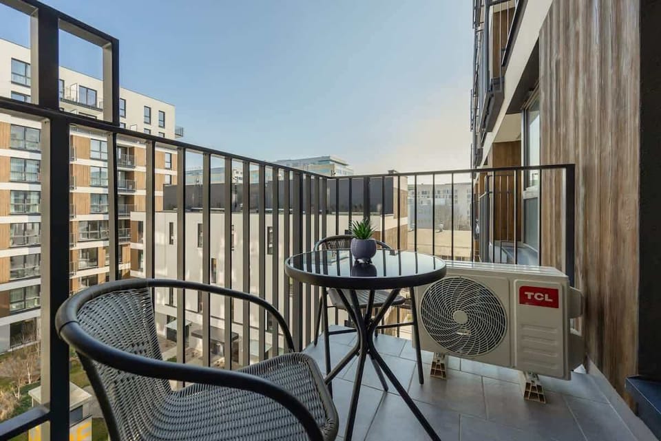 A balcony space with two chairs and a small table. Ideal for enjoying coffee with a view.