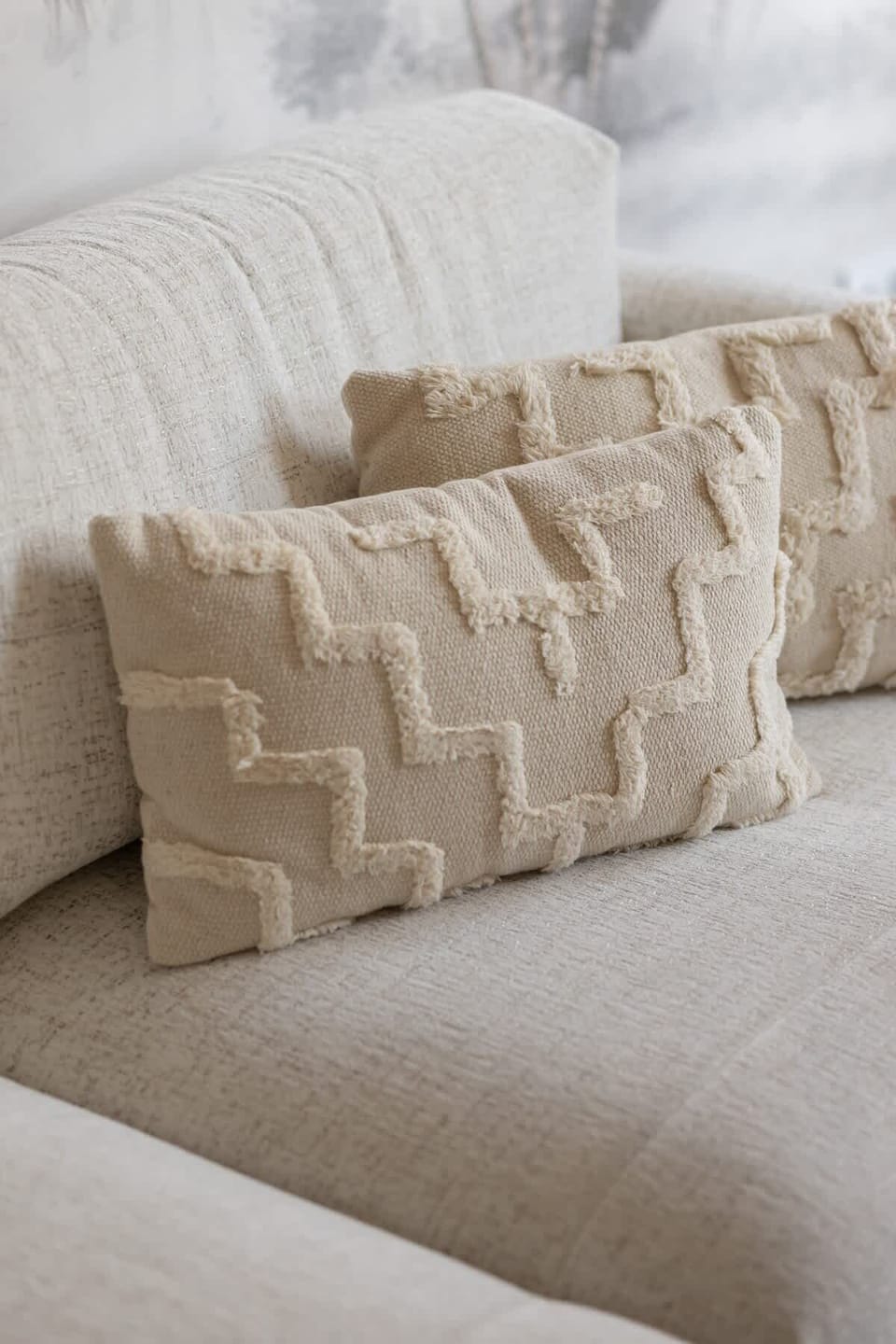 A close-up of a beige couch with textured cushions. Perfect for a cozy and stylish lounge area.