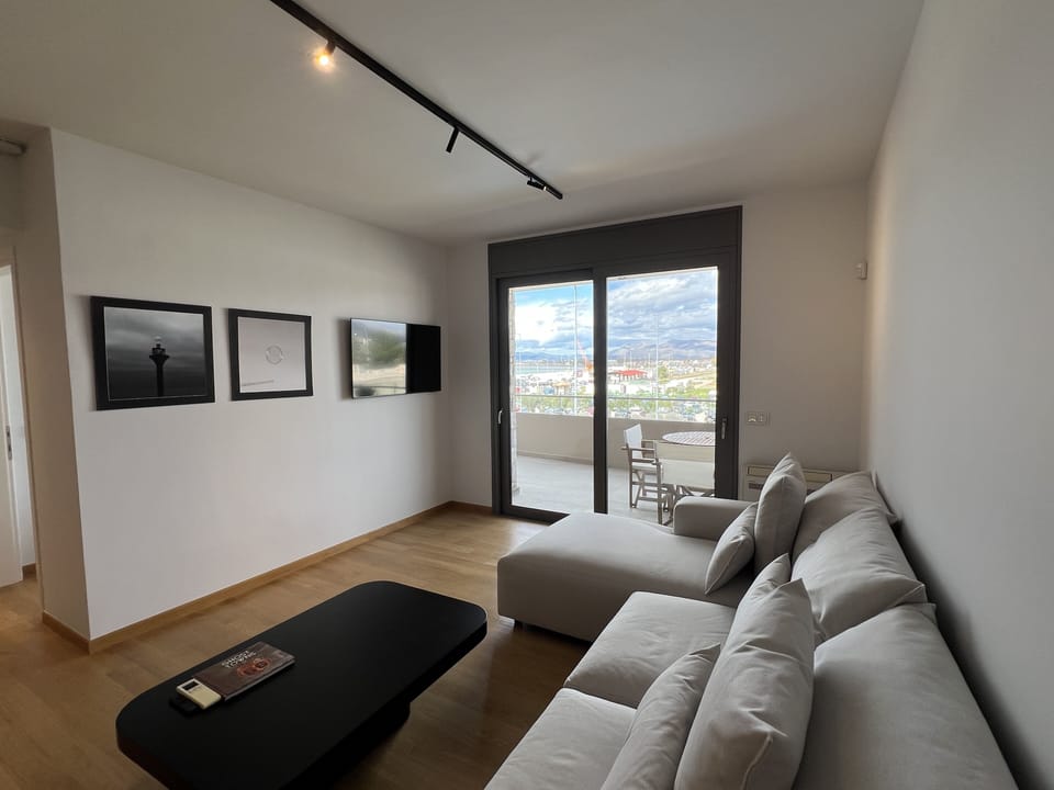 Living area and balcony view of the port