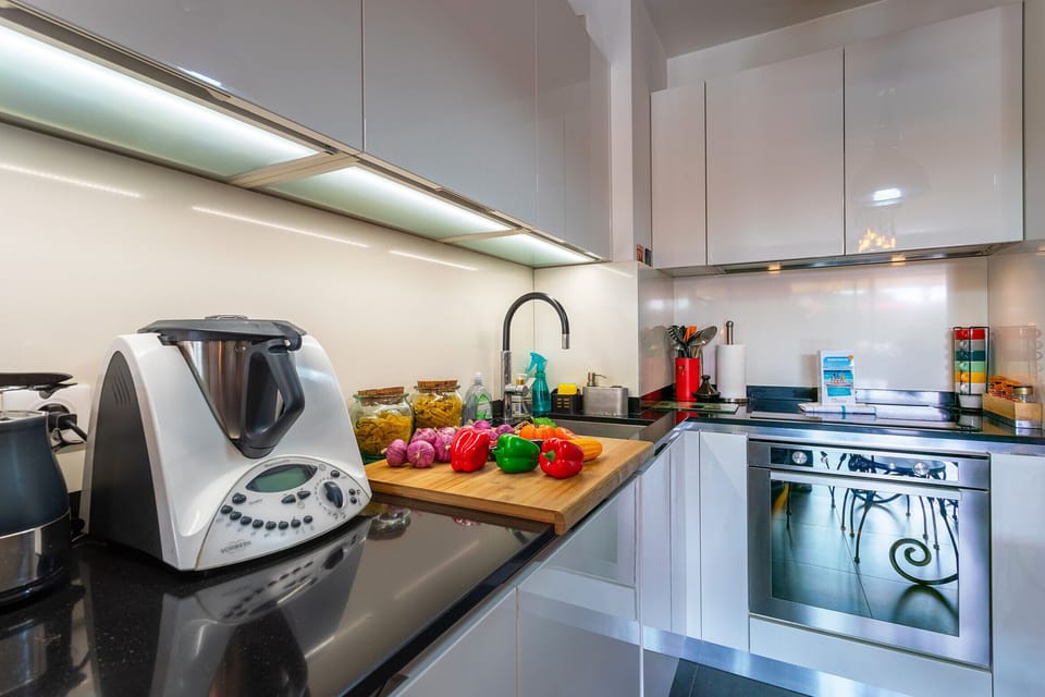 Modern fully equipped kitchen with a spacious countertop, perfect for preparing meals with else.