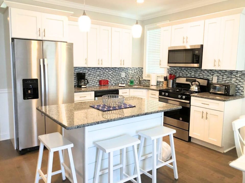 Modern kitchen with stainless steel appliances and granite island