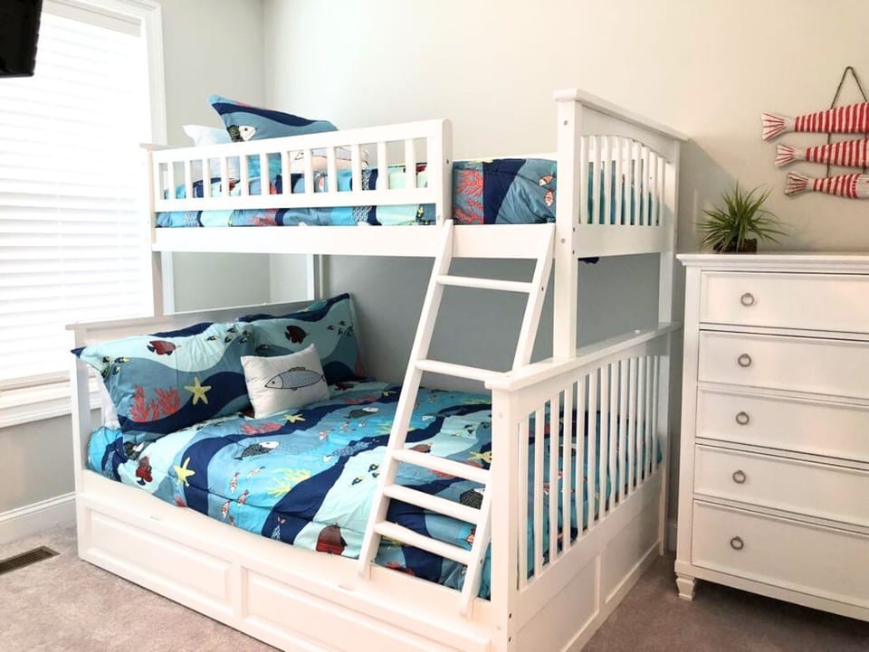 Playful kids’ bunk room with ocean-themed bedding