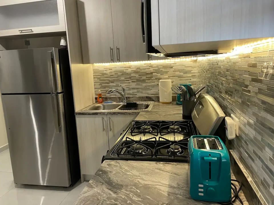 Another view of the well-equipped kitchen, perfect for preparing meals during your stay.