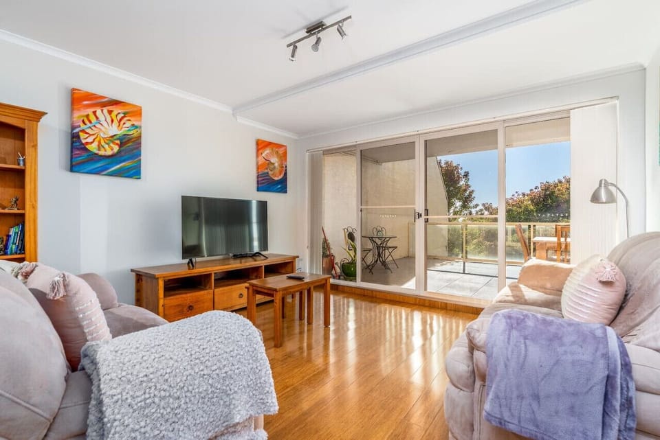 This living room invites you to relax on cosy seating, perfect for unwinding or socializing.