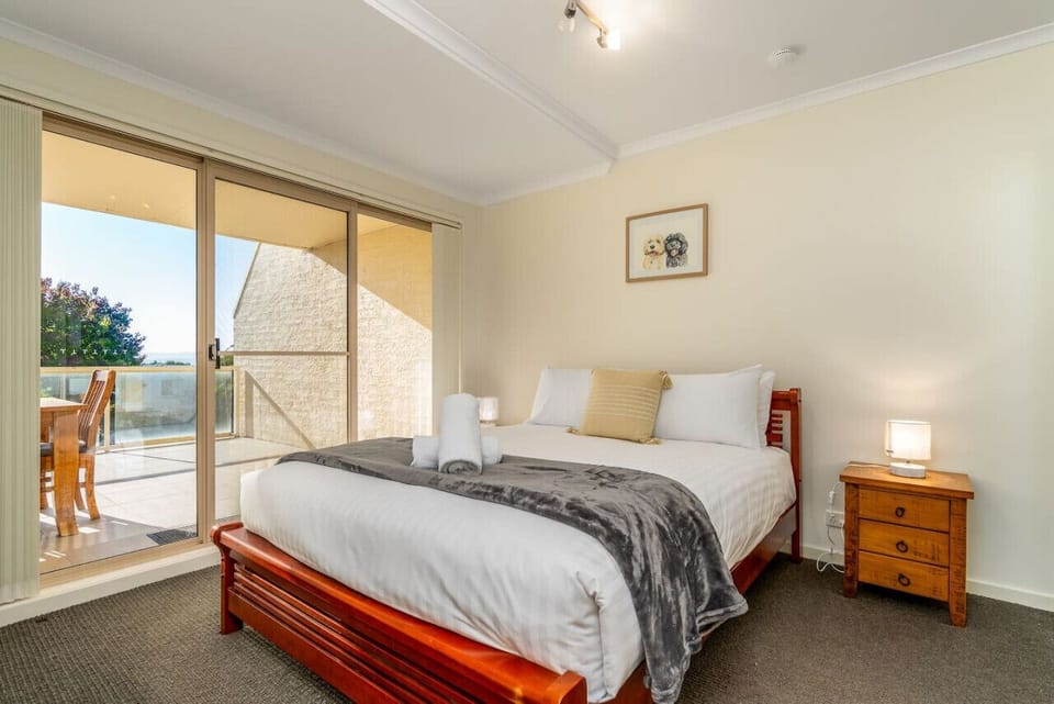 Rest and unwind in our sunlit queen-sized bedroom, adorned with simple yet elegant decor for a truly relaxing stay.