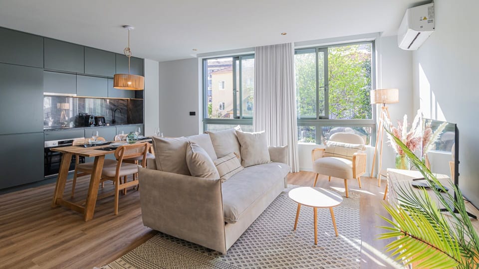 Relax in the sun-drenched living area, featuring cozy seating arrangements and large windows that flood the space with natural light! #bright #comfort