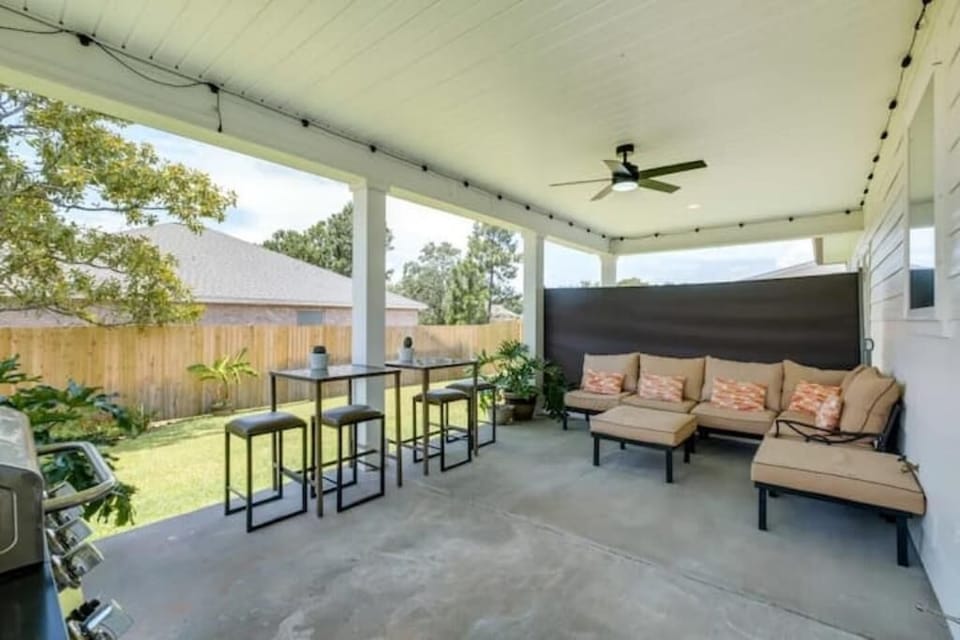 Back patio with covered porch and furnished with outdoor furnitures