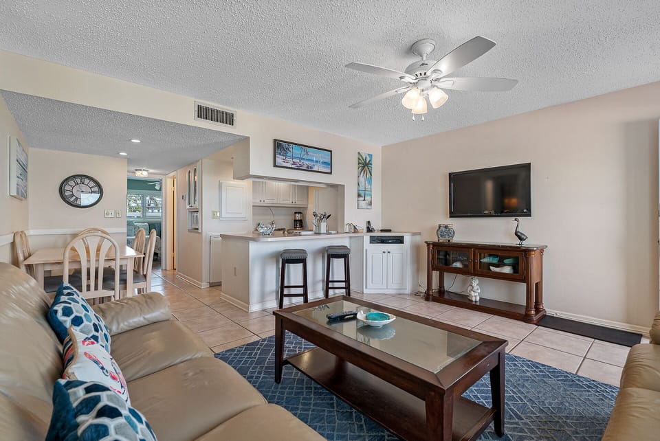 Relax in the living room with plenty of seating and natural light.