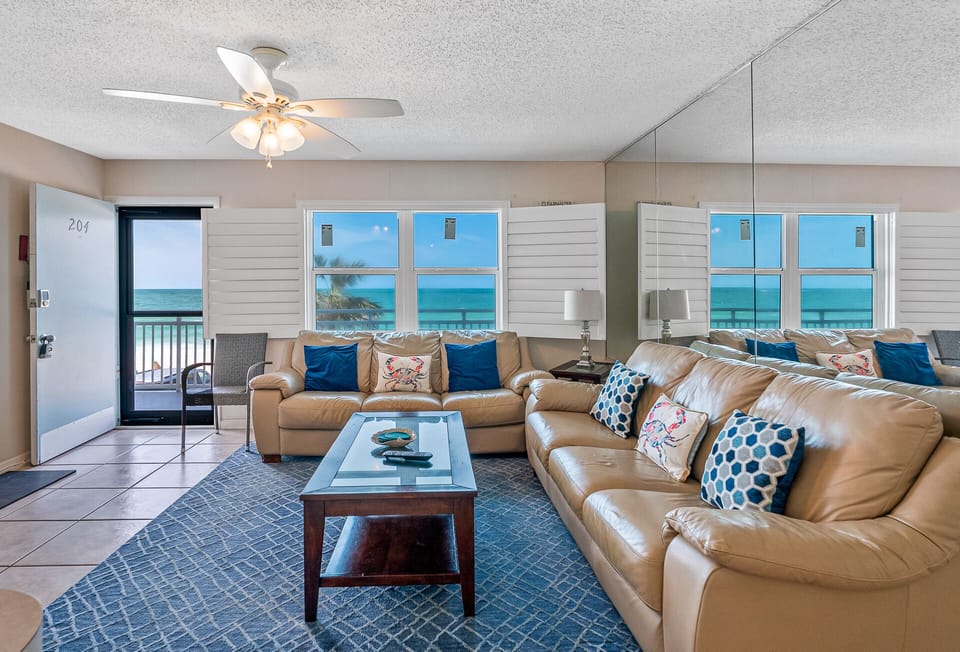Spacious living room with comfy seating and beautiful Gulf views.