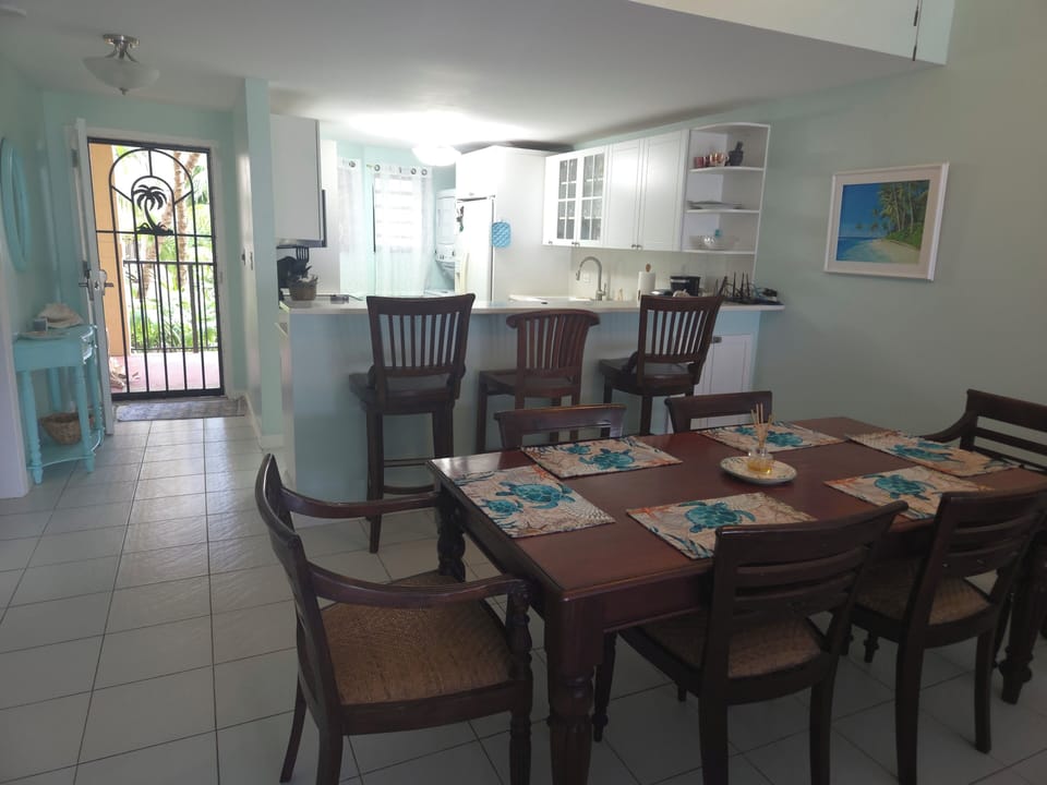 Dining area looking into entryway and kitchen