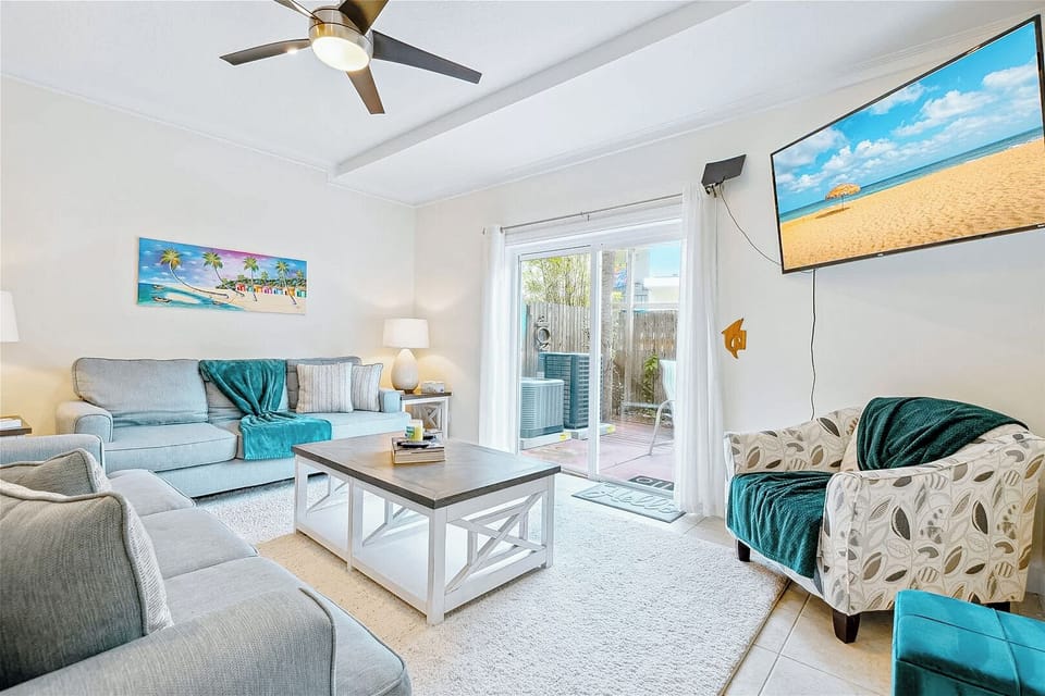 Stylish living room with beachy decor and seamless indoor-outdoor flow.