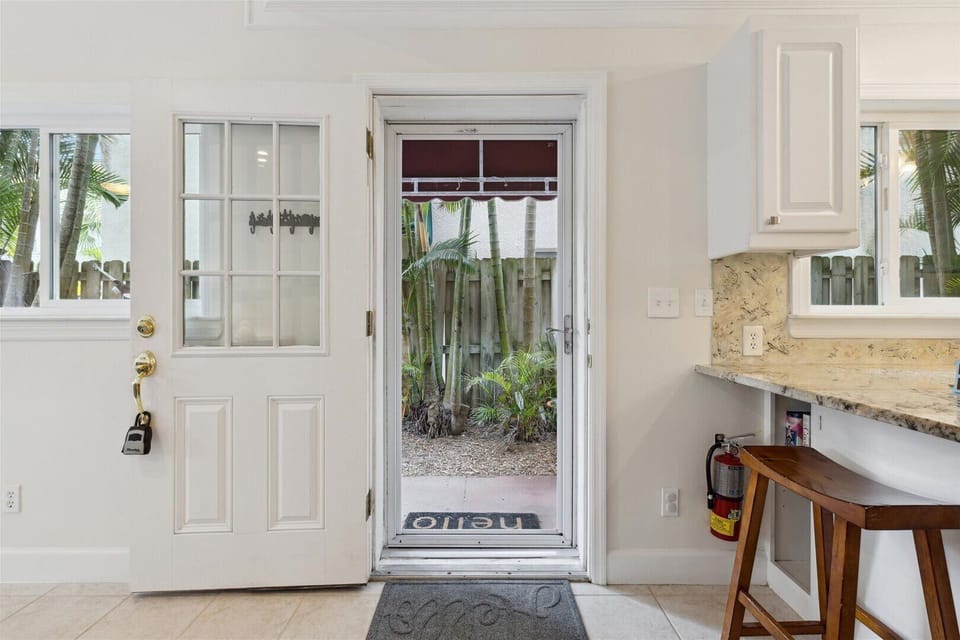 Inviting entryway with a glass door, bringing in sunshine & fresh vibes.