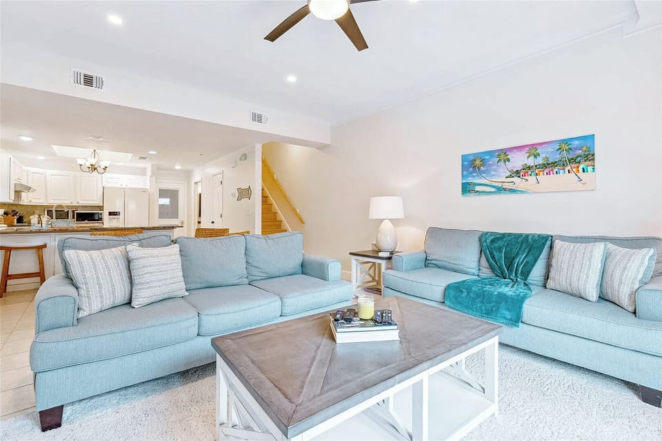 Spacious living room with coastal hues and plush seating for total comfort.