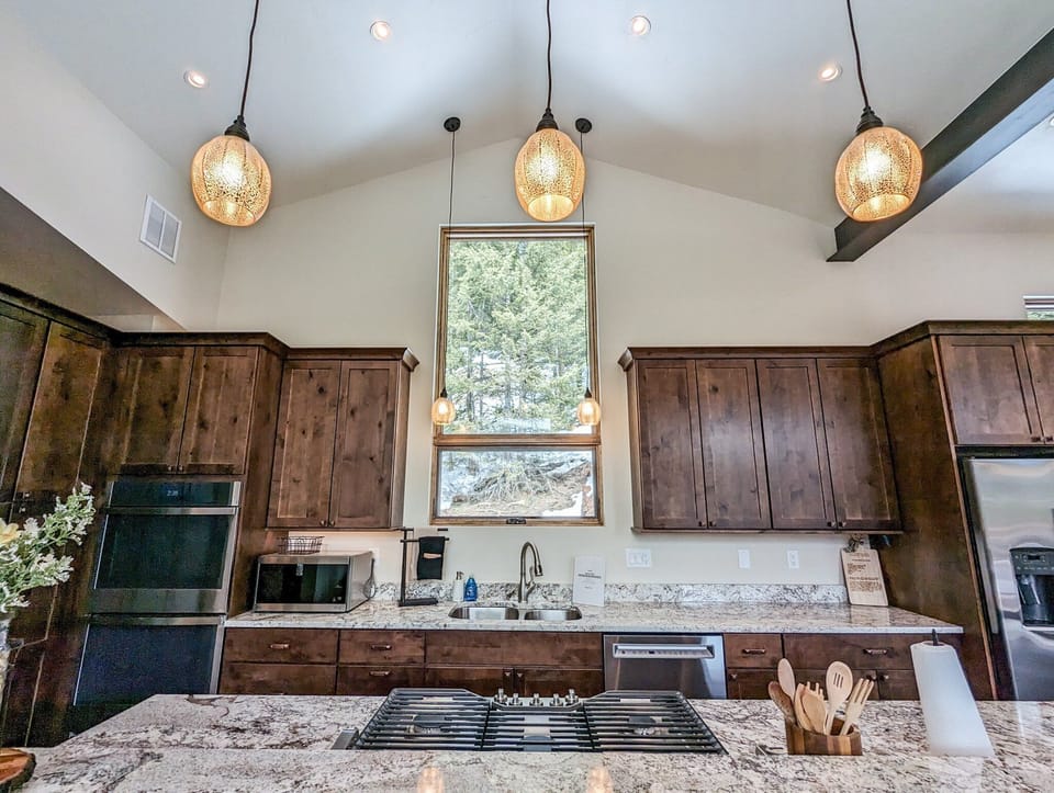 Equipped with top-of-the-line stainless steel appliances, granite countertops, and a spacious double island.