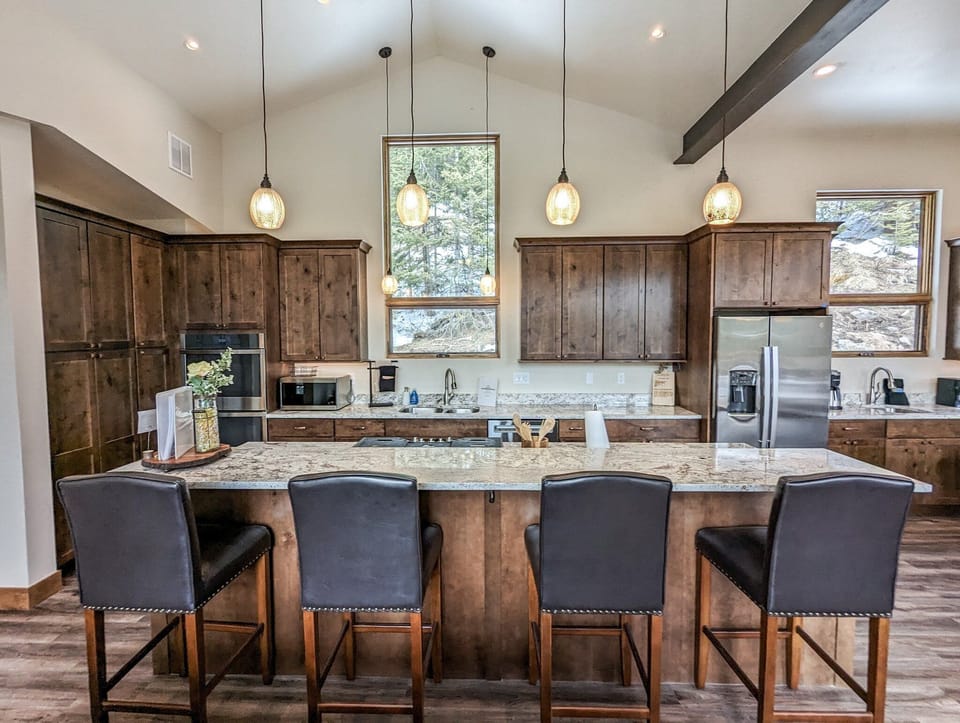 The well appointed kitchen and wet bar are full stocked with all the kitchen gadgets and accouterments you could desire and are perfect for whipping up gourmet meals