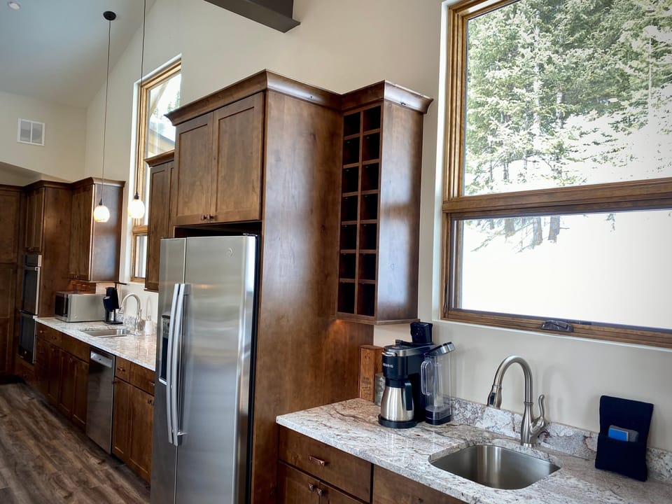 Equipped with top-of-the-line stainless steel appliances, granite countertops, and a spacious double island.