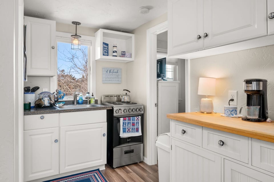 Kitchen area with bedroom and bathroom on either side