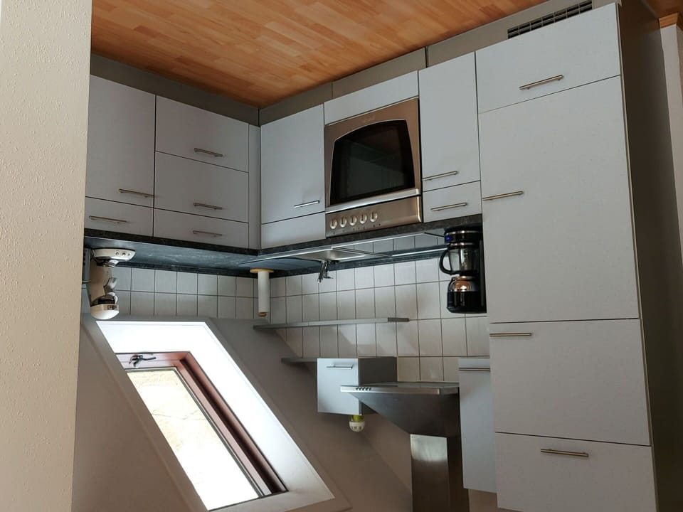 Wood, Kitchen Appliance, Cabinetry, Flooring, Kitchen, Countertop, Interior Design, Home Appliance, Major Appliance, Floor