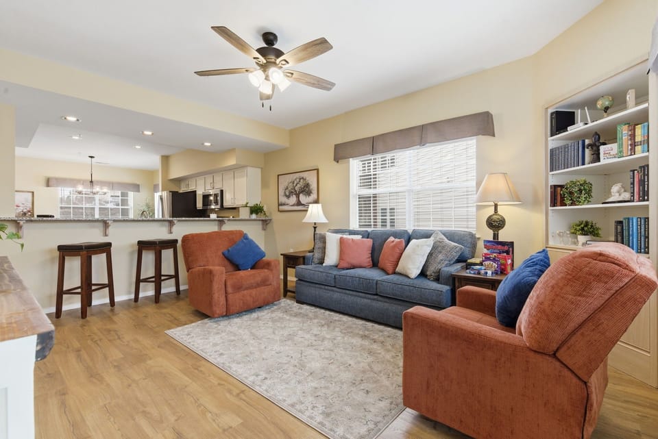 The updated living space features new furniture, a flat-screen TV with cable and streaming capabilities, and various card and board games.