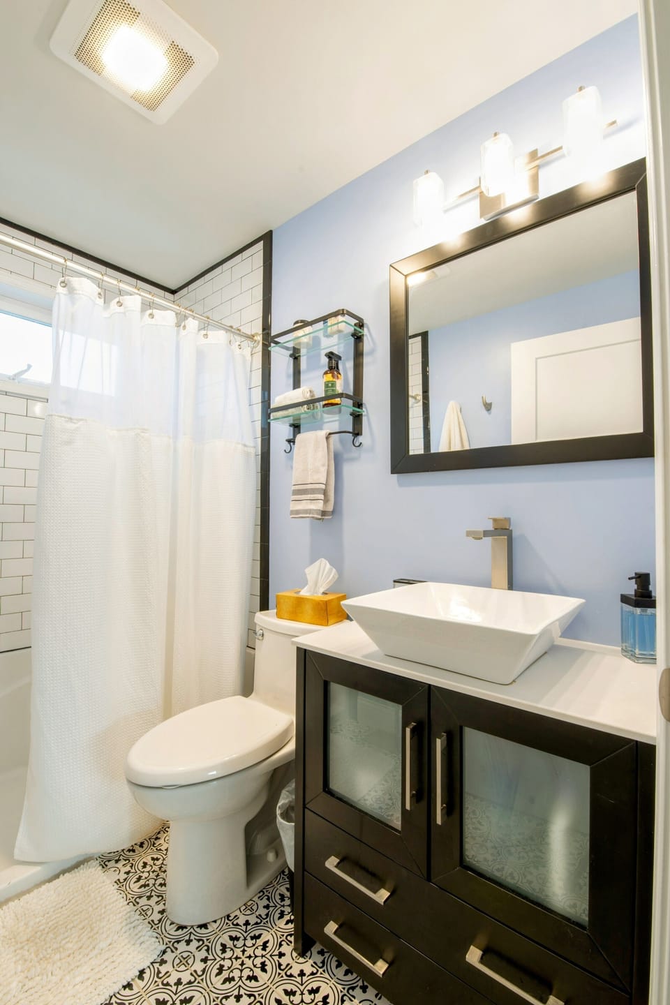 Bright, clean bathroom with full amenities.