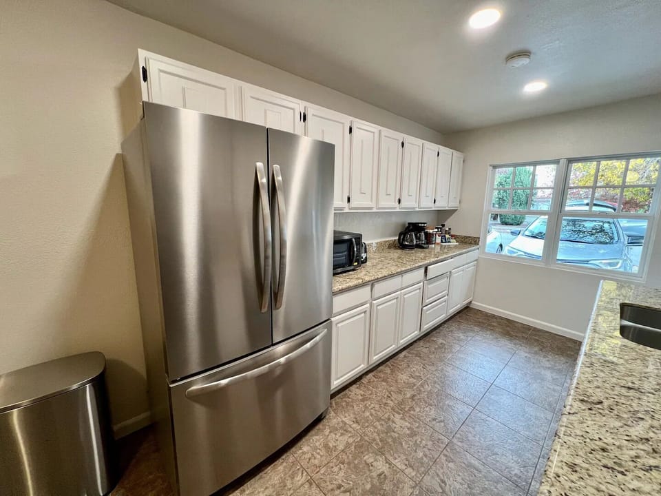 Fully stocked kitchen w/ fridge, stove, toaster, microwave, coffee maker, kettle