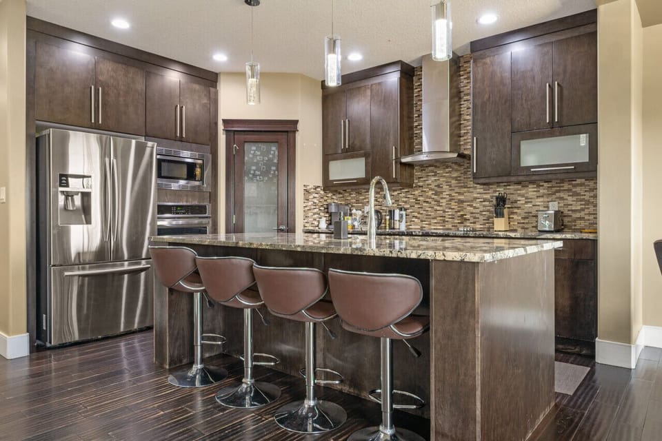Fully-equipped kitchen, boasting a ice maker, modern appliances, and a coffee machine for your morning brew.