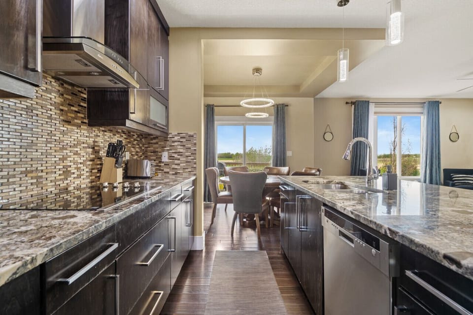 Fully-equipped kitchen, boasting a ice maker, modern appliances, and a coffee machine for your morning brew.