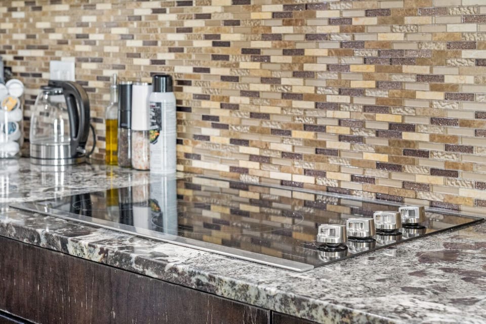 Fully-equipped kitchen, boasting a ice maker, modern appliances, and a coffee machine for your morning brew.