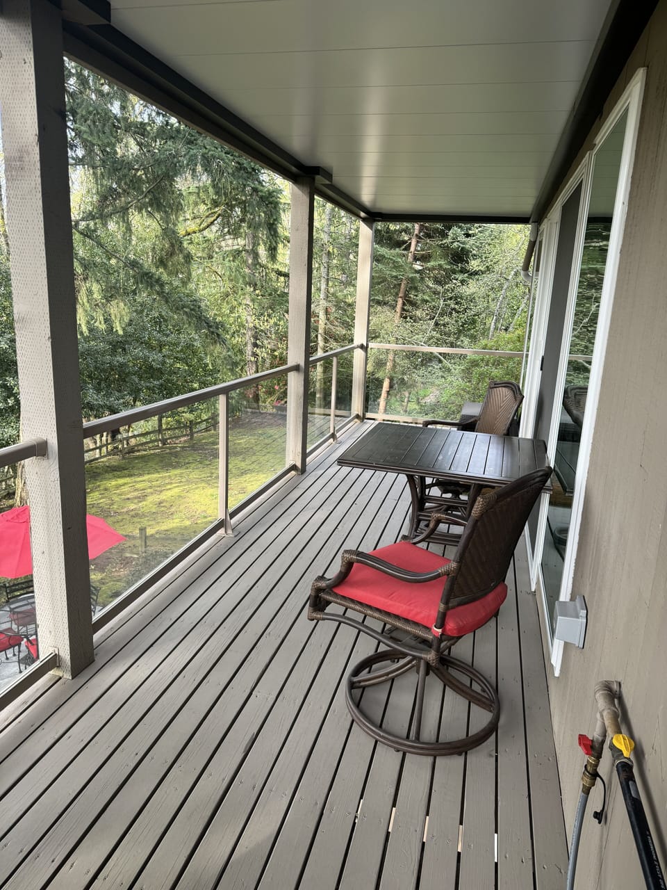 Covered deck overlooking mature wooded garden