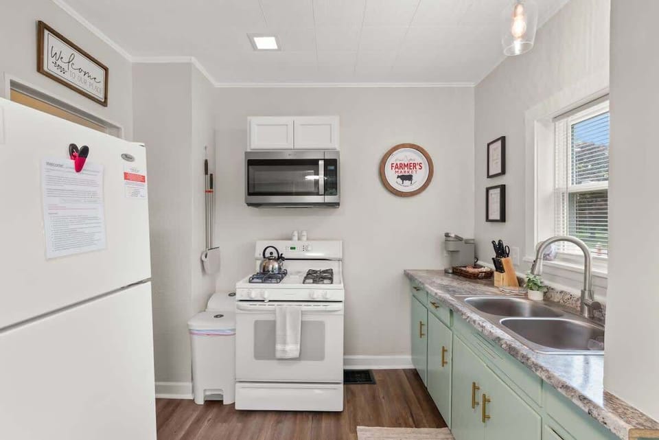 Light-filled kitchen w/ full-size fridge, stove & charming mint cabinets