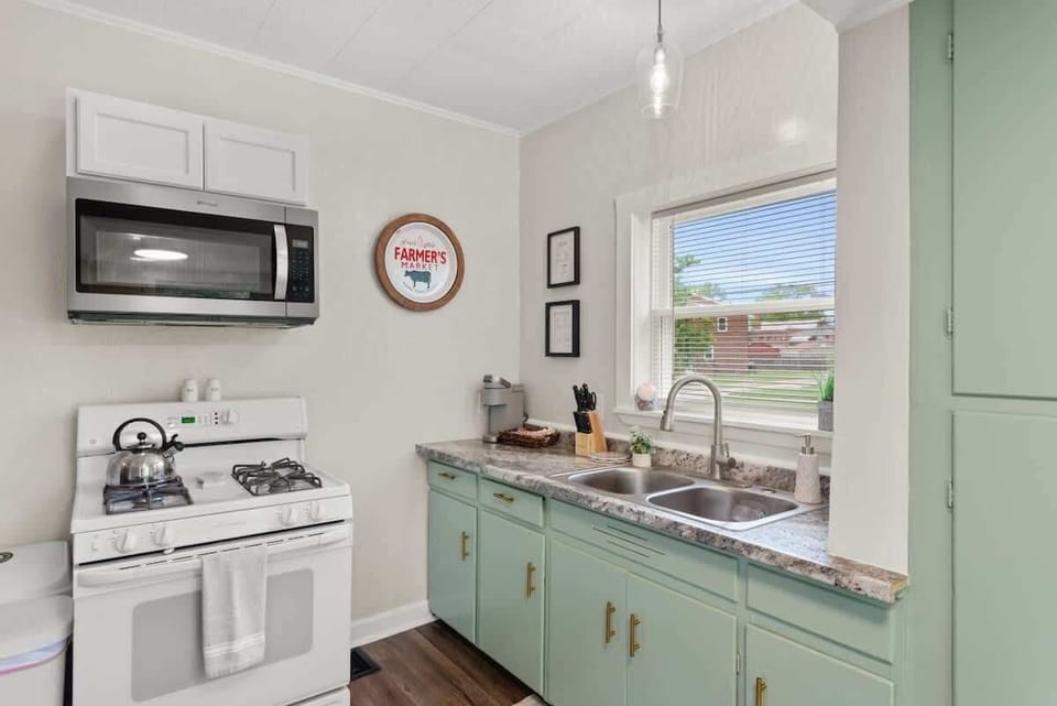 Fresh kitchen corner w/ microwave, stove & vintage-inspired mint cabinets