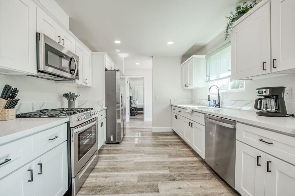 Modern kitchen with stainless steel appliances and sleek countertops.