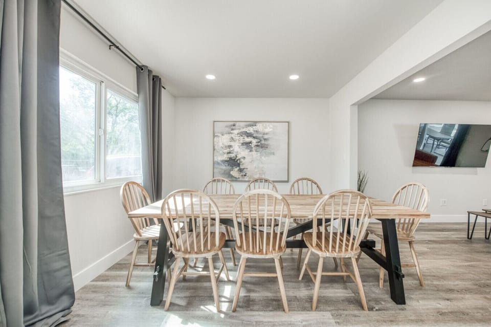 Dining area with a wooden table and modern decor for group meals.