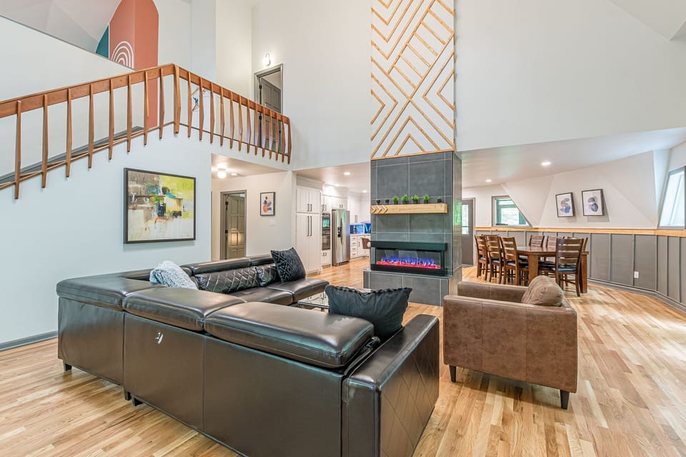 Living room has high ceilings and a fireplace