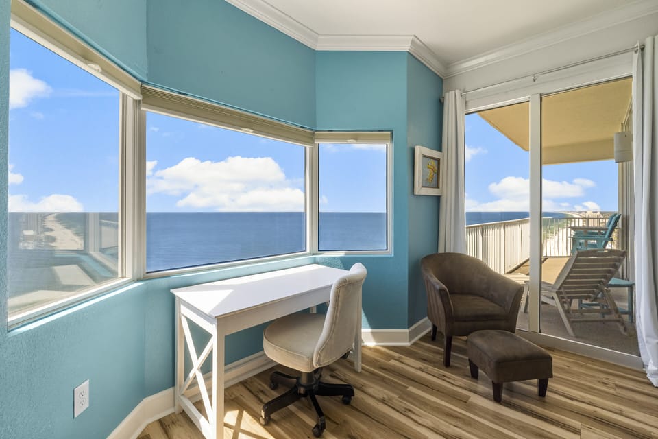 King-size master bed w/ private ensuite bath, workspace, & direct balcony access