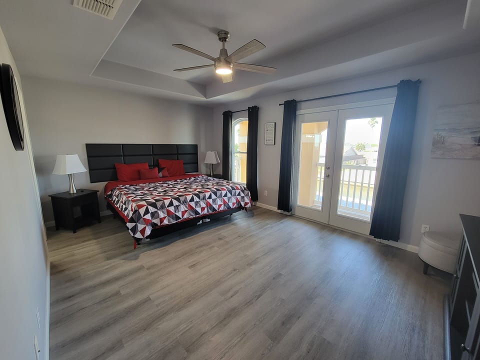 Primary room has doors that lead to balcony that overlooks the backyard.